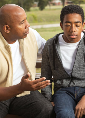 man having conversation with young man