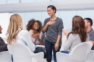 Woman talking in a group therapy session 
